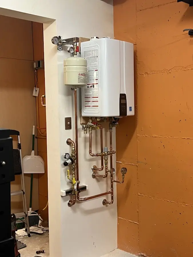 Plumbing technician inspecting water heater connections in Idyllwild-Pine Cove
